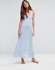 riveria ditsy printed maxi dress with low neckline and cross straps at the back