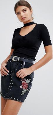 denim mini skirt with studs and rose embroidery
