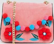 pink cross body bag with floral pom detail